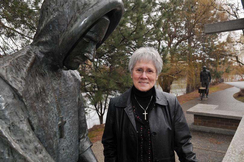 Sister Rosalie Locati, director of mission and values for Providence Sacred Heart and Providence Holy Family hospitals, stands beside Ken Spiering’s sculpture in Riverfront Park. It commemorates the arrival of the Sisters of Providence, who built Sacred Heart on the banks of the Spokane River in 1886. Locati is the only Sister of Providence still working full time at Sacred Heart Medical Center. (Jesse Tinsley)