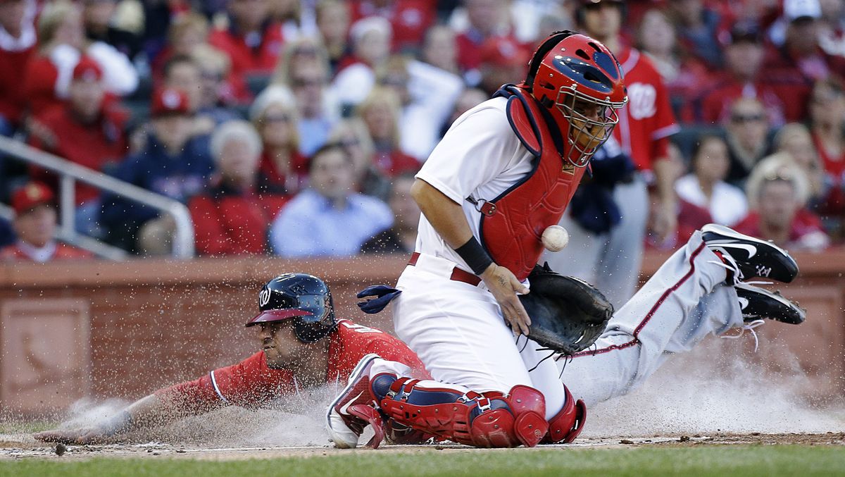 Washington’s Ian Desmond scores behind St. Louis catcher Yadier Molina on a single by Jordan Zimmermann during the second inning. (Associated Press)