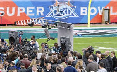 
Philadelphia Eagles wide receiver Terrell Owens is surrounded by a throng of reporters during the annual Media Day at Alltel Stadium in Jacksonville, Fla., on Tuesday. The Super Bowl guarantees wide publicity to stadium namesake Alltel.
 (Associated Press / The Spokesman-Review)