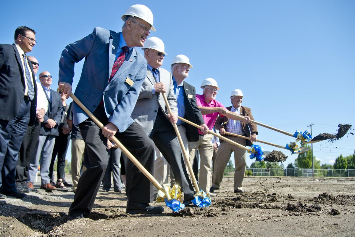 Spokane Valley city leaders in hardhats, from left, Bill Gothmann, Mayor Rod Higgins, Ed Pace, Arne Woodard and Sam Wood turn dirt to ceremonially break ground for the new Spokane Valley City Hall near the corner of Sprague and Dartmouth on the old U-City Mall site Thursday, June 9, 2016. (Jesse Tinsley / The Spokesman-Review)