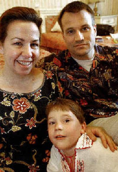 
Vasile Wilcox, a Romanian child adopted by a U.S. family, poses with his parents, Emily Wilcox, left, and Andy Wilcox in a Bucharest, Romania, hotel on May 10. Vasile Wilcox, a Romanian child adopted by a U.S. family, poses with his parents, Emily Wilcox, left, and Andy Wilcox in a Bucharest, Romania, hotel on May 10. 
 (Associated PressAssociated Press / The Spokesman-Review)