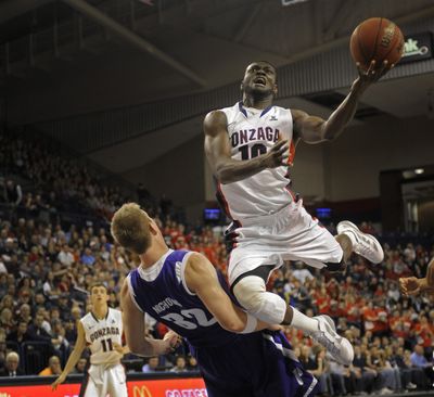Guy Landry Edi of Gonzaga flies over the defense of Ryan Nicholas of Portland on Dec. 28, 2011. (Christopher Anderson)