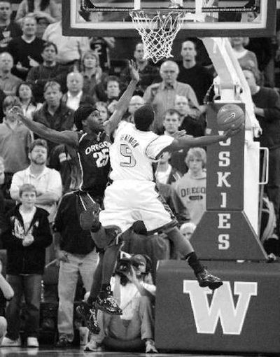 
Washington guard Justin Dentmon draws a first-half foul on Oregon's Chamberlain Oguchi. 
 (Associated Press / The Spokesman-Review)