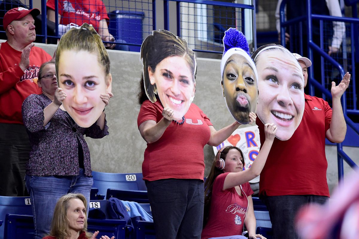 Fans hold Gonzaga player heads before the game with LMU, Thur., Feb. 9, 2017, in the McCarthey Athletic Center. (Colin Mulvany / The Spokesman-Review)