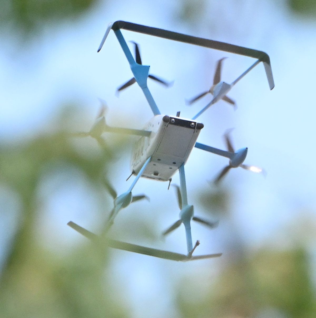 An Amazon drone flies above the treetops in Pontiac as it heads to deliver a package to a customer on July 28, 2026.  (Daniel Mears/The Detroit News/TNS)