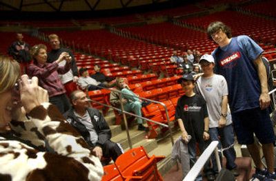 There's very little rest when you're the star. Gonzaga's leading scorer Adam Morrison, posing with Zags fans on Wednesday, know's that all too well.
 (Brian Plonka / The Spokesman-Review)