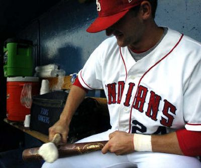 
Spokane Indians outfielder Steve Murphy rubs a cow bone over his bat before last week's game against the Vancouver Canadians. 
 (Holly Pickett / The Spokesman-Review)