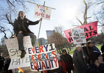 
Gay marriage proponents protest Tuesday outside the Statehouse in Boston, where lawmakers  voted  to allow a proposed state constitutional amendment banning gay marriage to move forward. 
 (Associated Press / The Spokesman-Review)