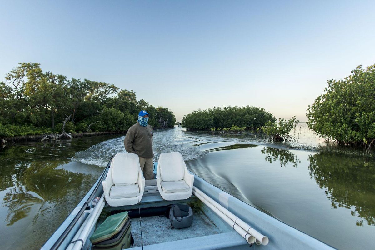 Tarpon fishing guide Darwin Vega Cruz motors fly fishers to tarpon water near Mexico’s Isla Holbox, north of Cancun. (Courtesy of Michael Visintainer)