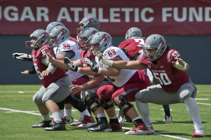 Washington State University linemen protect on a field goal attempt during the Crimson and Gray spring football game, April 26, 2014, at Joe Albi Stadium. (Dan Pelle / The Spokesman-Review)