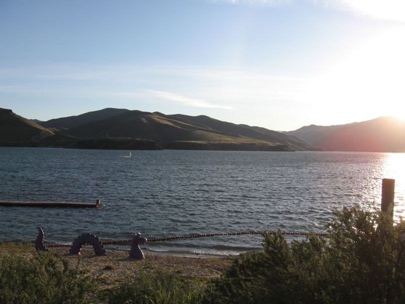 Lucky Peak Lake just after sunrise Tuesday, where a lone windsurfer skimmed across the water. (Betsy Russell)