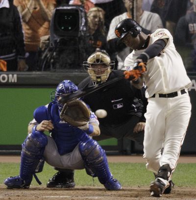 Edgar Renteria of the Giants hits a two-run single in the eighth inning of Thursday night’s game. (Associated Press)