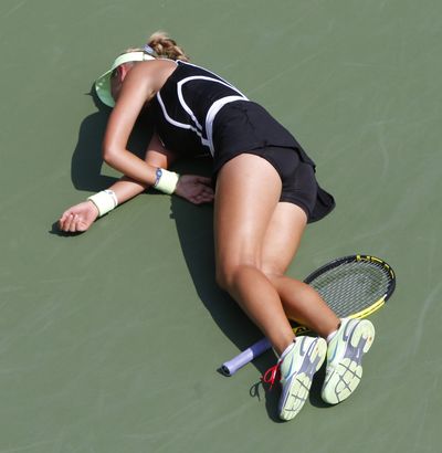 Victoria Azarenka of Belarus collapses on the court while playing Gisela Dulko of Argentina at the U.S. Open tennis tournament.  (Associated Press)