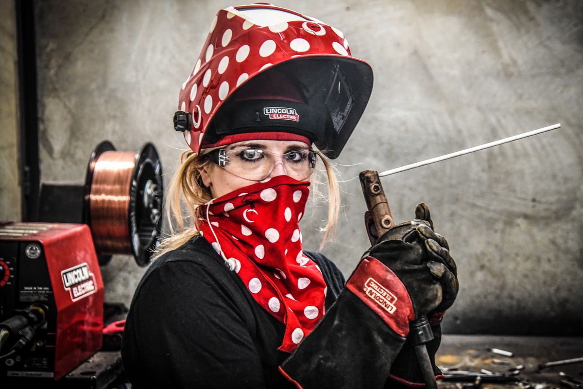 Carissa Wahl, a welding student at Spokane Community College, pauses while practicing for a test on July 23.  (Dan Pelle / The Spokesman-Review)