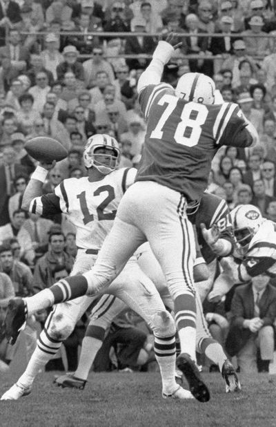 In this Jan. 12, 1969 photo, New York Jets quarterback Joe Namath (12) throws the ball against the Baltimore Colts in Super Bowl III in Miami. Just over 50 years ago, halfway through the history of the NFL, the New York Jets completed one of the most unexpected championship seasons in the history of the sport when a brash quarterback named Joe Namath helped engineer a Super Bowl victory over the heavily favored Baltimore Colts. That now-famous journey by Broadway Joe and the boys through the AFL that ended in triumph in Miami took a lesser-known detour for the second week of the schedule. Yes, for one weekend, the Jets actually landed in Birmingham, Alabama, at Legion Field. (Associated Press)