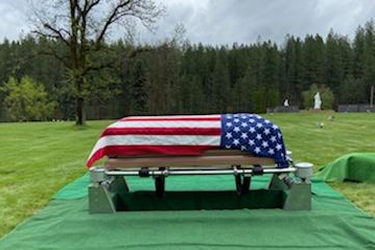A flag is draped over the coffin of Eldon Walton, who died in Spokane of COVID-19. (Jerry Pederson / Courtesy Jerry Pederson)