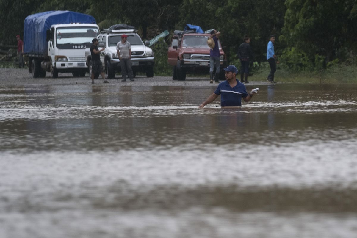 A man walks through a flooded road in Okonwas, Nicaragua, Wednesday, Nov. 4, 2020. Eta weakened from the Category 4 hurricane to a tropical storm after lashing Nicaragua
