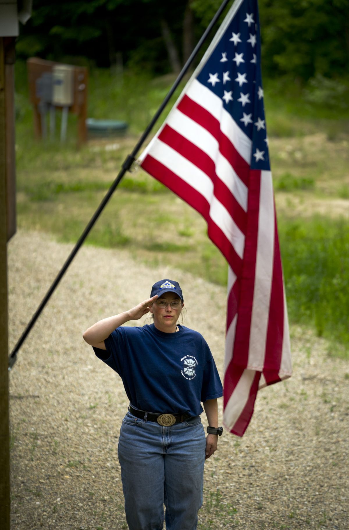 Jennifer Barcklay salutes the flag before retiring it for the evening at her rural Spokane County home on June 8. (Colin Mulvany)