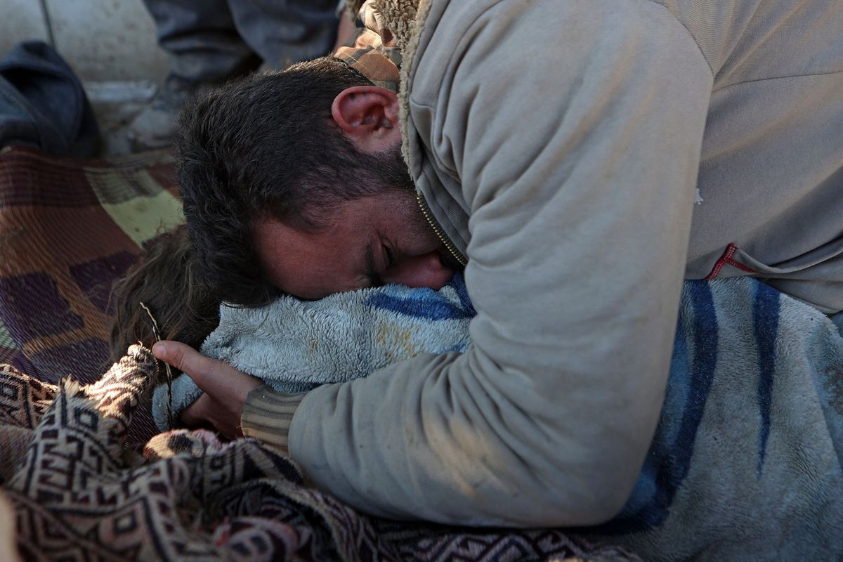 A Syrian man cries over the body of his lifeless child in the rebel-held town of Jindayris on Tuesday, following a deadly quake. - The Syrian Red Crescent appealed to Western countries to lift sanctions and provide aid after a powerful earthquake has killed more than 1,600 people across the war-torn country.  (Tribune News Service)