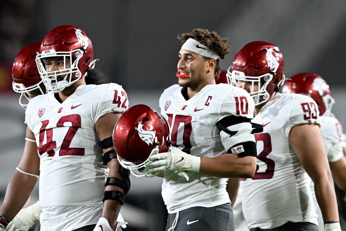 Defensive tackle Antonio Pule III (42) and defensive end Ron Stone Jr. (10) have helped hold up Washington State’s strongest unit.  (Tyler Tjomsland/The Spokesman-Review)