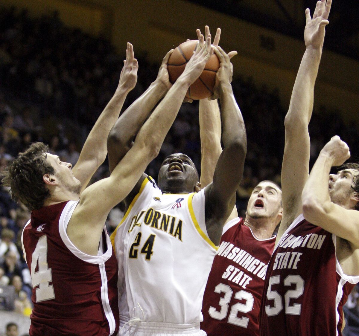 California’s Theo Robertson is swarmed by the Cougars’ defense in the second half.   (Associated Press / The Spokesman-Review)