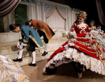 
Jamil Jacaman, left,  Gerardo Vidales, center, and Scarlet Ann Moreno  prepare for a final dress rehearsal for the Society of Martha Washington Colonial Pageant celebration in Laredo, Texas, on Thursday. Below, Princess Pocahontas, portrayed by Kristian D. Martinez, talks on her cell phone before the parade Saturday.
 (Associated Press photos / The Spokesman-Review)