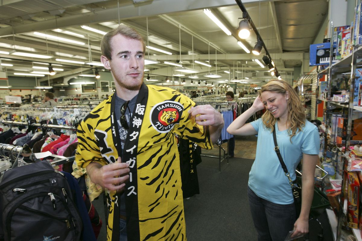 Auburn University student Ryan Jordan gets a laugh from his girlfriend, Haden Little, as he tries on a Hanshin Tigers “gi” that he found in the clothing aisles at Unclaimed Baggage Center in Scottsboro, Ala. (Associated Press)