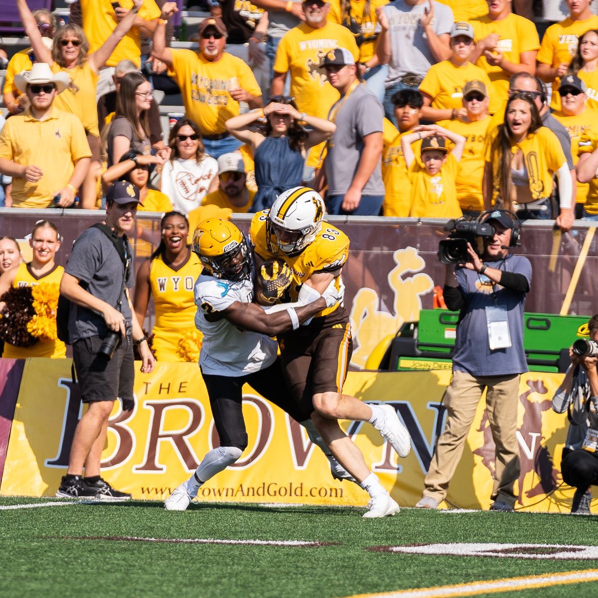 Idaho Vandals defensive back Abraham Williams tackles Wyoming Cowboys wideout Will Pelissier during a game on Saturday at War Memorial Stadium in Laramie, Wy.  (Courtesy of Idaho Athletics)