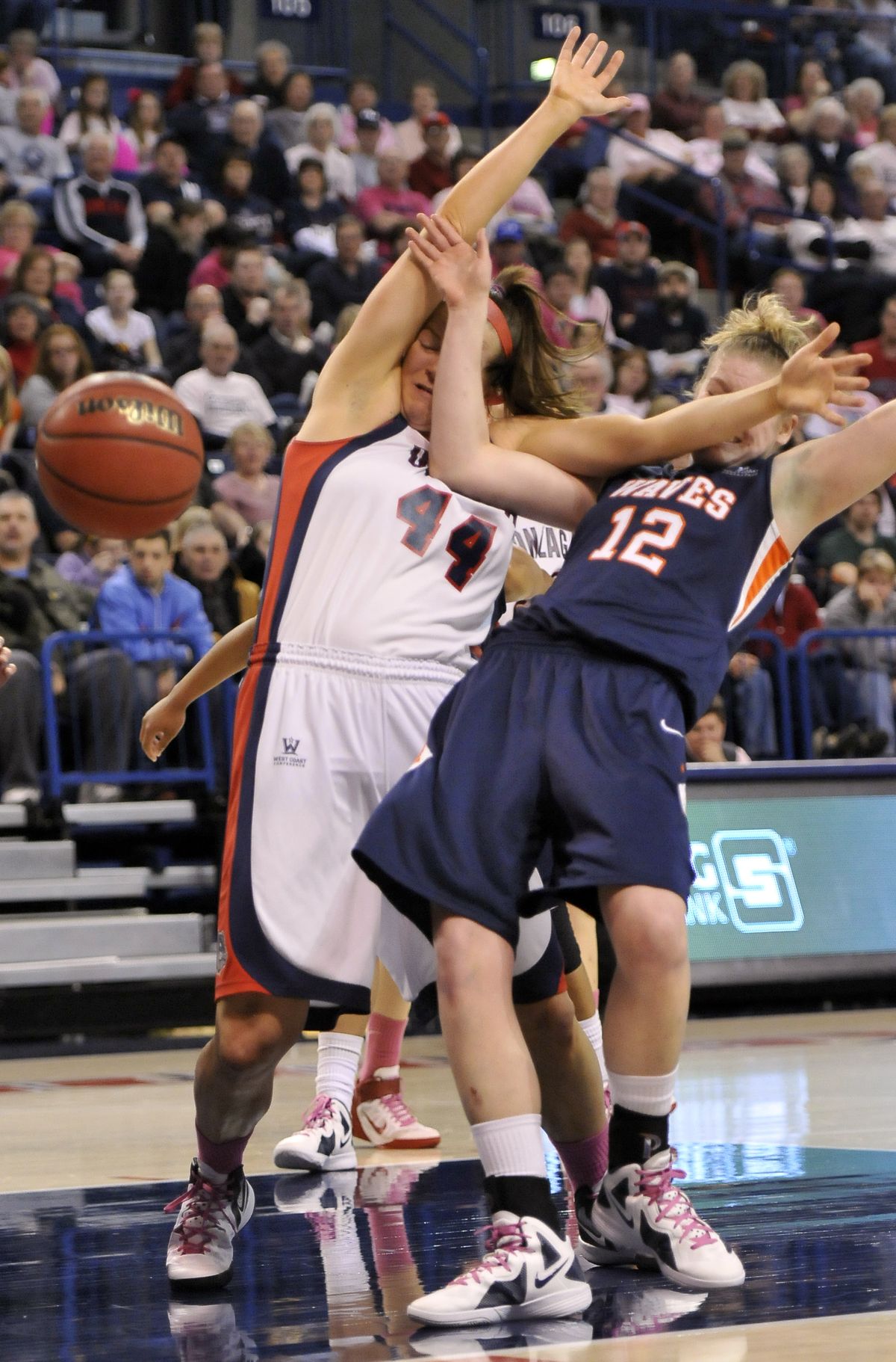 Gonzaga’s Kelly Bowen, left, commits a foul and sends Pepperdine’s Kelsey Patrick to the floor while boxing out for a rebound on Saturday. (Jesse Tinsley)