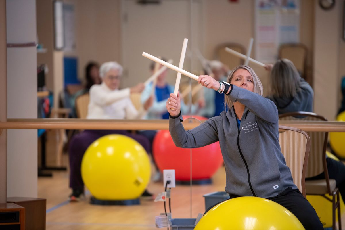 Instructor Dawn Olson demonstrates techniques and rhythm patterns for her pupils in a “DrumFit” class at Touchmark South Hill center Nov. 6. Using PVC pipe “drumsticks” and fitness balls as drums, the class offers mental awareness, a physical workout with moderate exertion.  (Jesse Tinsley/THE SPOKESMAN-REVIEW)