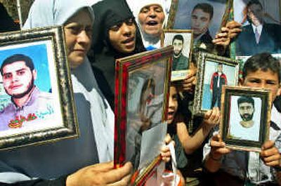 
Relatives of Palestinian prisoners held in Israeli jails demand their release during a protest in Gaza City on Monday. 
 (Associated Press / The Spokesman-Review)