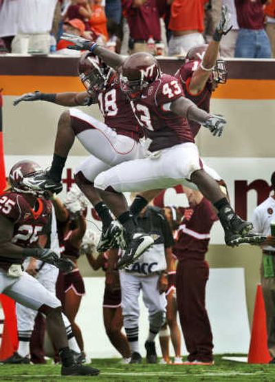 
A TD by Virginia Tech's Victor Harris, right, was also a high point for Jason Worilds, far left, and Brandon Flowers. Associated Press
 (Associated Press / The Spokesman-Review)
