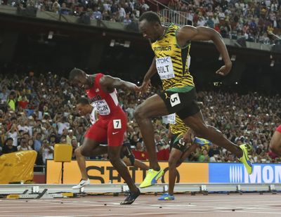 Jamaica’s Usain Bolt crosses the finish line just ahead of American Justin Gatlin, left, to win the men’s 100 meters. (Associated Press)