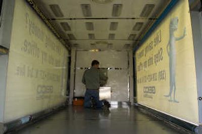 
Steve Cada, of Samann Investments, checks the signs on the side of the GoGreen Mobile Media van on  Nov. 6.  Moving lighted or electrically powered  signs could be subject  to  traffic fines. 
 (CHRISTOPHER ANDERSON / The Spokesman-Review)