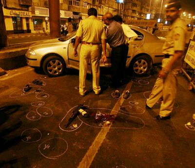 Police inspect a car after fatally shooting  two terrorism suspects Wednesday night in Mumbai, India.  (Associated Press / The Spokesman-Review)