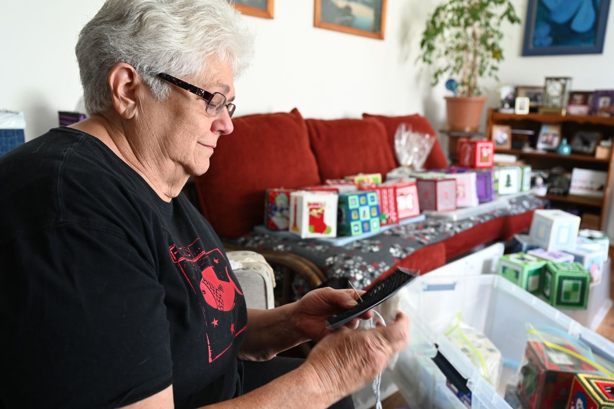 Darlene Kruse, photographed Tuesday, Aug. 10, 2021, slowed by her recovery from a broken leg a few years ago, began making tissue box covers out of plastic canvas and yarn while sitting in her TV chair at her Shadle Park Neighborhood home. She’s made enough to begin selling them online and, possibly, at fall craft shows. (Jesse Tinsley/THE SPOKESMAN-REVI)