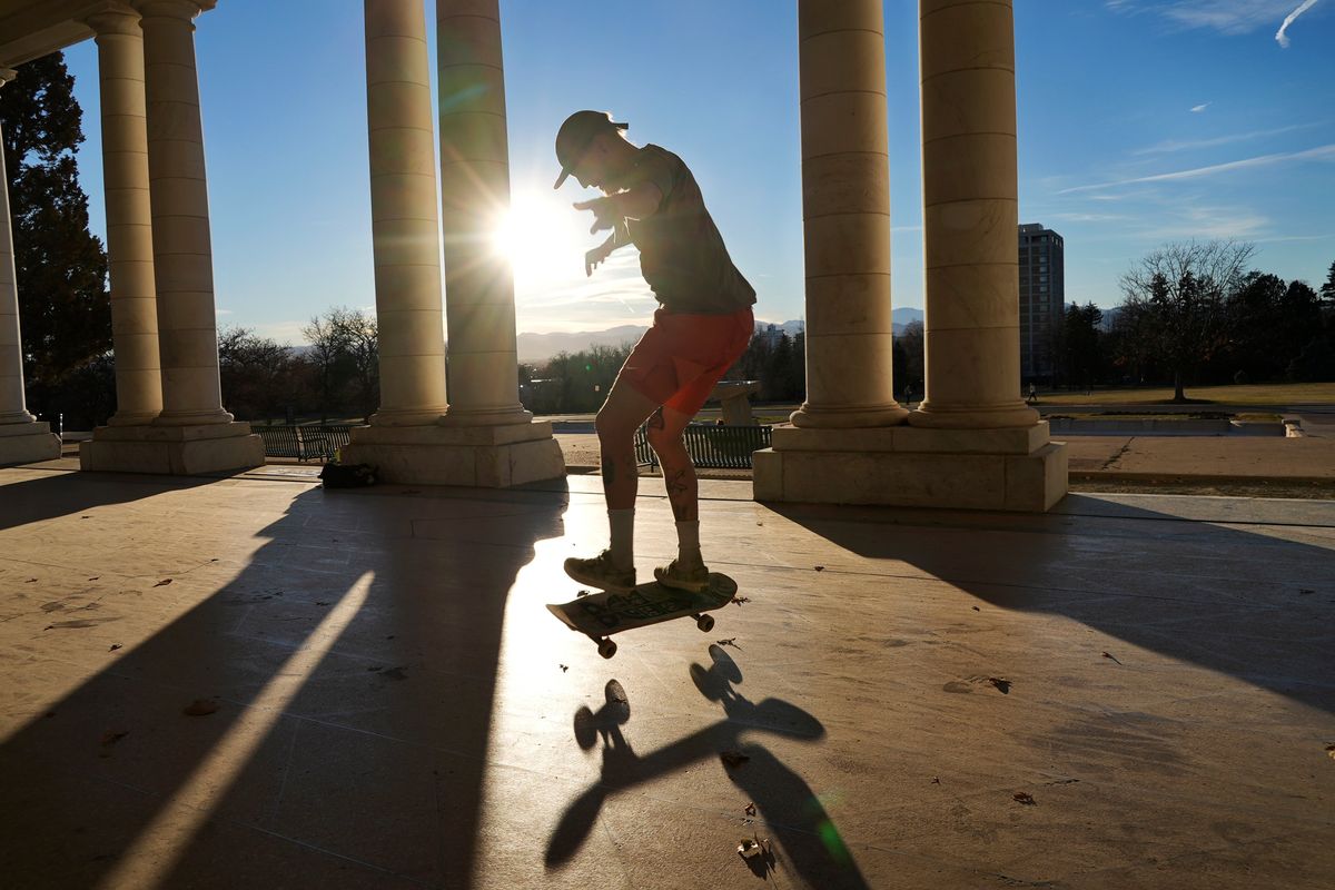 Drew Darnell rides his skateboard at Cheesman Park Pavilion on Wednesday in Denver. The city is close to breaking a record for its longest streak ever without snow.  (Brittany Peterson)