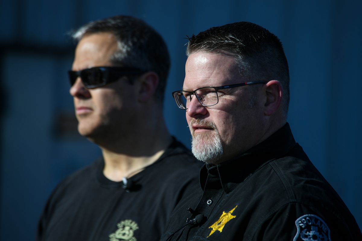 Spokane Police Sgt. Steve Braun, left, and Spokane County Undersheriff Mike Kittilstved talk with the media after a demonstration of new bomb robot and bomb suits for the Spokane Regional Explosives Disposal Unit, Tuesday, April 27, 2021, at Felts Field.  (Dan Pelle/THESPOKESMAN-REVIEW)