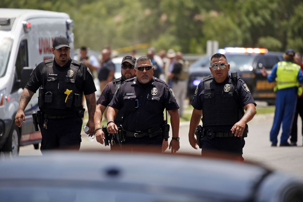 Police walk near Robb Elementary School following a shooting, Tuesday, May 24, 2022, in Uvalde, Texas.  (Dario Lopez-Mills)