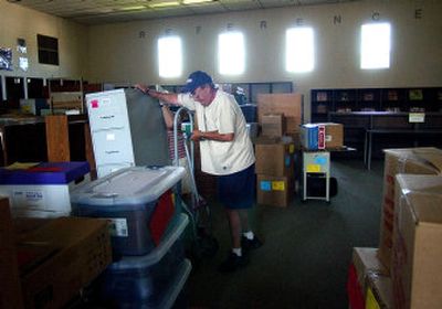 
Marlan Iverson brings a filing cabinet into the library at University Center. Several programs, including ECEAP, Even Start and the Native American Program, will move to  University Center in a shuffle that will put kindergartners at Barker Center. 
 (Liz Kishimoto / The Spokesman-Review)