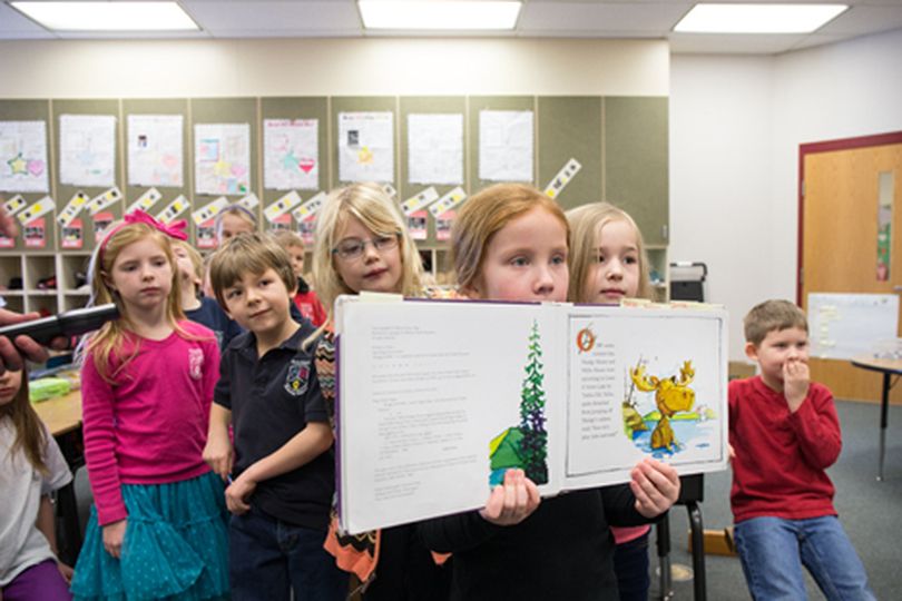 Ramsey Elementary first-grader Sophie Bailey shows a picture from ���Mudgy and Millie��� by Susan Nipp Tuesday morning in Casey Campbell���s class as students met with a first-grade class from New York state via live video using the Idaho Education Network. (Gabe Green/press)