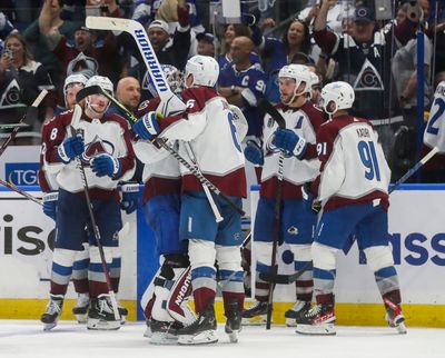 Colorado Avalanche players celebrate the game-winning overtime goal by center Nazem Kadri (91) against the Tampa Bay Lightning in Game Four of the Stanley Cup final Wednesday, June 22, 2022, at Amalie Arena in Tampa, Florida.  (Tribune News Service)