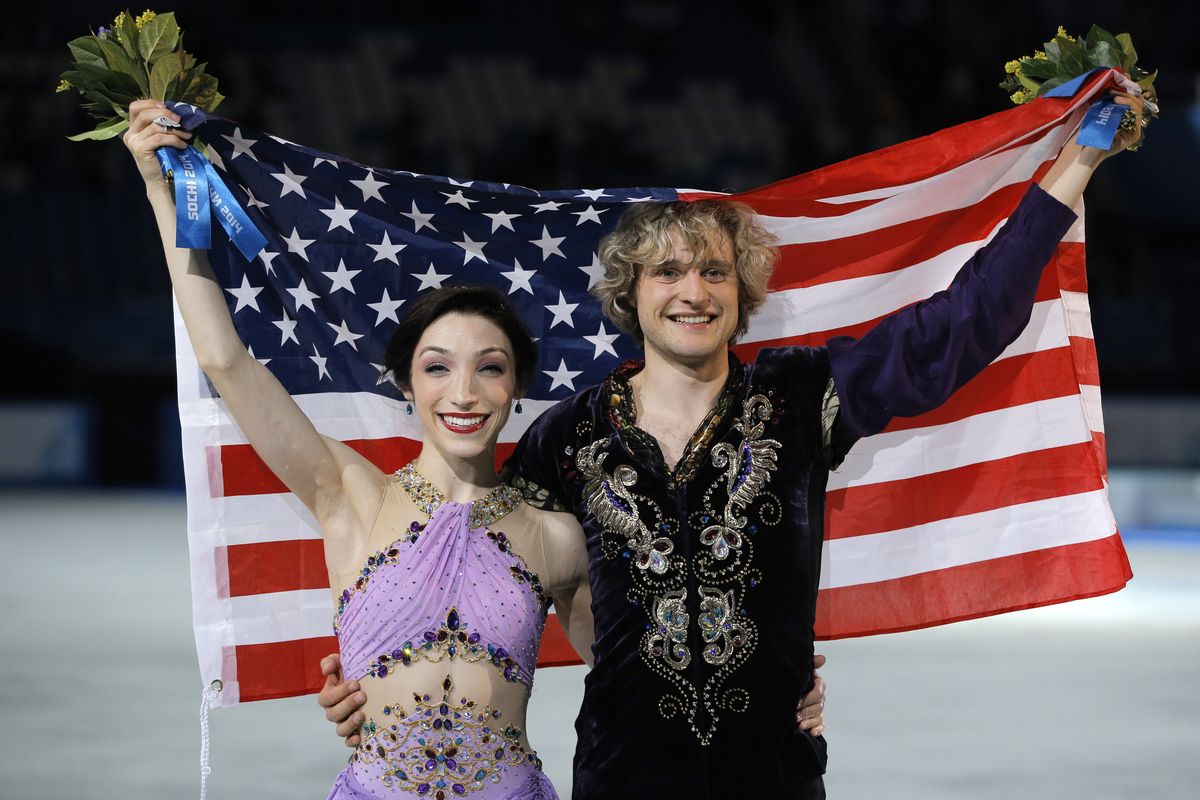 Meryl Davis and Charlie White of the United States pose for photographers after placing first in the ice dancing free dance finals Monday in Sochi, Russia. (Associated Press)