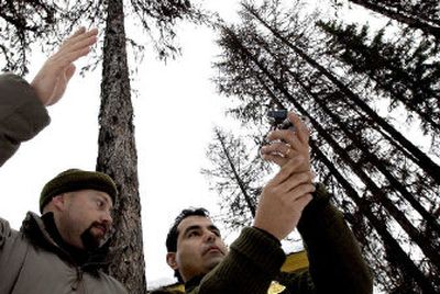 
U.S. Border Patrol agent Jose Leal, right, of Bonners Ferry, Idaho, gets a few pointers on using a compass from Matt Smith, a National Park Service ranger from Davenport, during the Law Enforcement Mountain Operations School at the Priest Lake Ranger Station in Bonner County on Thursday. 
 (Kathy Plonka / The Spokesman-Review)