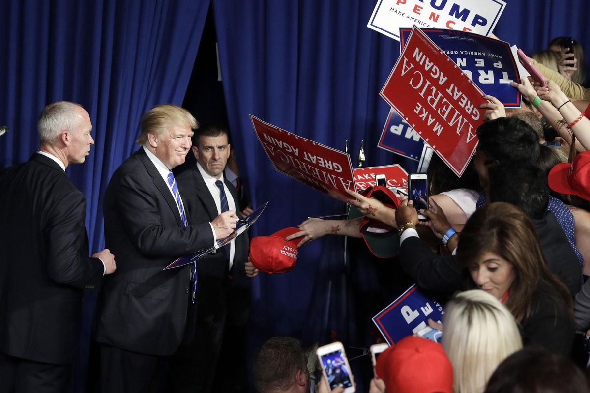 Republican presidential candidate Donald Trump meets with supporters after a rally, Friday, Sept. 30, 2016, in Novi, Mich. (John Locher / Associated Press)