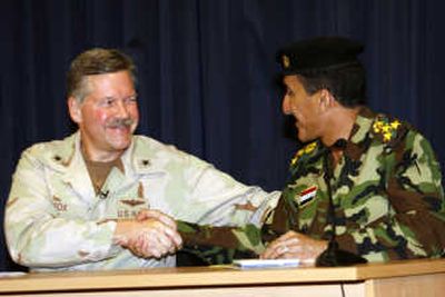 
Iraqi Gen. Qassim Atta,  right, and U.S. Navy Rear Adm. Mark  Fox shake hands at the end of a joint press conference at the Green Zone in Baghdad on Sunday. Associated Press
 (Associated Press / The Spokesman-Review)