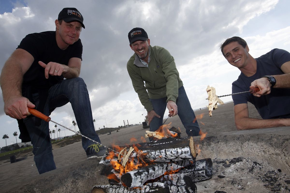 Beyond Meat company officers, from left, Ethan Brown, founder; Tony Prudhomme, CEO; and Brent Taylor, co-founder, demonstrate how their faux chicken cooks like the real thing on an open fire near their El Segundo, Calif., headquarters on Nov. 4.
