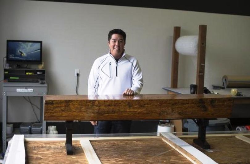 Reid Hatley with one of the benches his company RHI Golf made for Tiger Woods’ first golf course, Bluejack National, at his new shop in Hayden, Idaho. In mid-June an arsonist burned down Hatley’s former manufacturing shop and offices on a nearby lot by the Coeur d’Alene Airport. (Tyler Tjomsland / The Spokesman-Review)