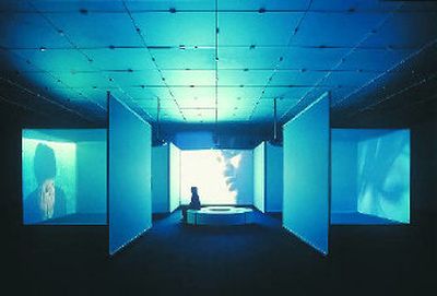 Four scenes cycle across three screens in Doug Aitken's video installation,