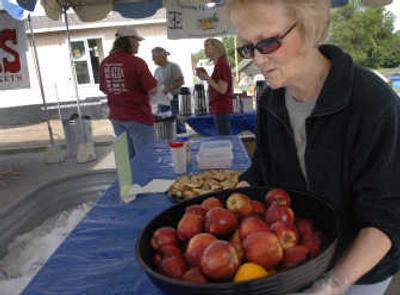 
Milissa Looker arranges snacks for fellow Habitat for Humanity volunteers at the 2007 Blitz Build on East Boone Avenue in Spokane on June 15. Looker has lived in her own Habitat home for more than two years.
 (Holly Pickett / The Spokesman-Review)